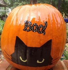 a pumpkin with a black cat painted on it