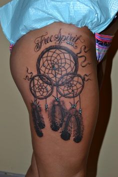 a woman's thigh with a tattoo on it that says free spirit and a dream catcher