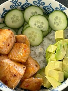 a bowl filled with rice, cucumbers and meat