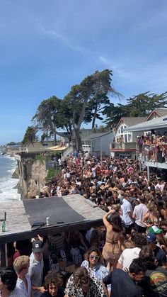 a large group of people standing on top of a beach