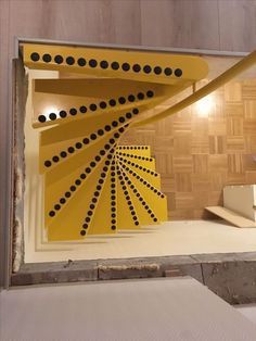 a room that has some yellow and black designs on the wall in front of it