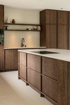 a large kitchen with wooden cabinets and white counter tops, along with an island in the middle