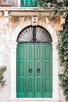 an old building with two green doors