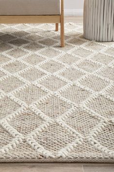 a white rug on the floor next to a chair