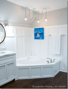 a large white bath tub sitting next to a bathroom sink