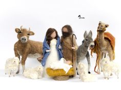 a nativity scene with sheep, lambs and donkeys on a white background