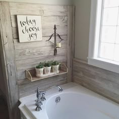 the bathroom is decorated with wood planks and has a white bathtub in it