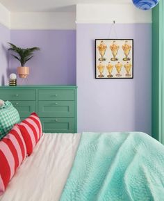 a bedroom with purple walls and green furniture