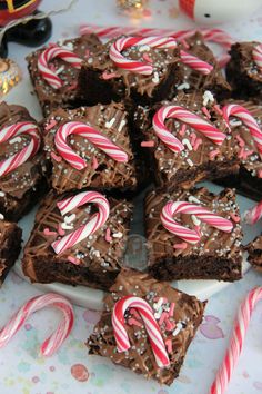 there are many brownies with candy canes on the table