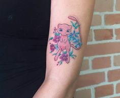 a woman with a tattoo on her arm has a pink and blue flowered pokemon pikachu