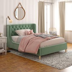 a bedroom with pink bedding and wooden floors