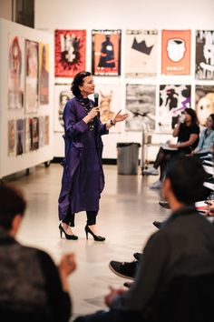 a woman standing in front of a group of people