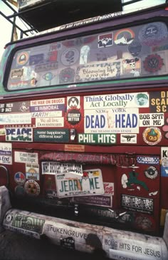 an old bus covered in stickers and decals