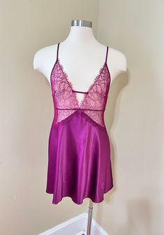 Vintage Victoria's Secret Satin Maroon/Deep Wine  Chemise Slipdress Short Nightie. Floral sheer mesh lace bodice with eyelash trim. Deep V neck with criss-cross, adjustable spaghetti straps, metal sliders. Soft satin polyester 97% and elastane 3%. Slightly flared skirt, nice drape. Chemise  is in excellent vintage condition with no stains or defects noted.  Size Large, relaxed fit. Check measurements below for accurate sizing.  Bust 36" Underbust 32-33" Waist about 38" Length from top of bust to hem 28" not including strap. Please see all photos of this Victoria's Secret Maroon/Wine Chemise Slip dress  for complete description. Note computer monitors may vary in display of color. Please convo with questions or for additional photos. This shop does not accept returns or exchanges. Please co Womens Nightgowns, Women's Nightgowns, Pajama Robe, Satin Slip, Satin Slip Dress, Lace Bodice, Flared Skirt, Deep V, Flare Skirt