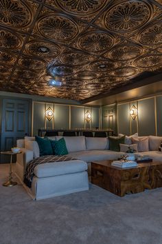 a living room filled with furniture and a ceiling covered in intricately designed tining