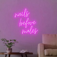 there is a neon sign that says nails before males on the wall next to a couch