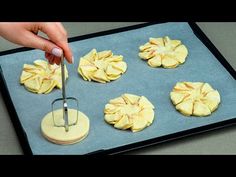 someone is cutting apples on a cookie sheet