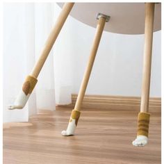 two wooden poles with socks on them are standing in the middle of a wood floor