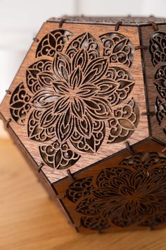 an intricate wooden box sitting on top of a table