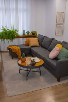 a living room filled with furniture and plants