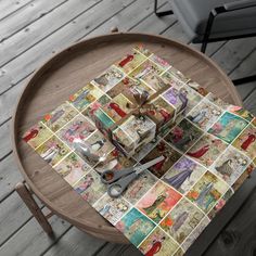 a wooden table topped with lots of different types of wrapping paper on top of it