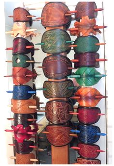 a rack with many different types of leathers on it's sides and hanging from the ceiling