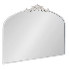 a large white mirror with an ornate design on the top and bottom corner, against a white background