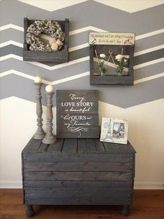 a wooden bench sitting in front of a wall with three pictures on it and a sign that says love story