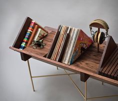 a wooden table topped with lots of books and headphones on top of each other