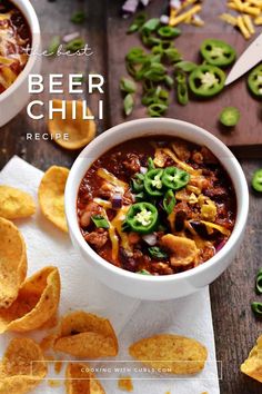 a bowl of beer chili with tortilla chips and green peppers on the side