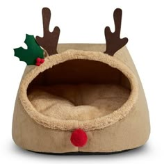 a dog bed with reindeer antlers on it's ears and nose, sitting in front of a white background