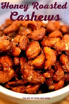 honey roasted cashews in a white bowl on a wooden table with text overlay