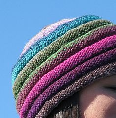 a woman wearing a multicolored knitted hat