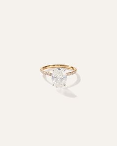 a gold ring with a pear shaped diamond