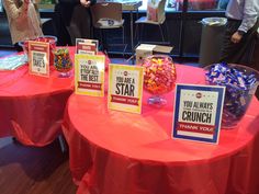 two round tables with candy and cards on them at a business event, one table has a sign that says you are the star