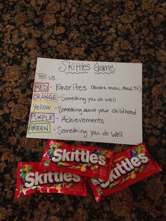 two skittles are sitting on the counter next to a sign that says skittles games