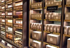 the shelves are filled with lots of bottles and boxes on them, along with labels that read biscuits