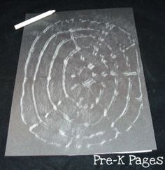 a piece of paper that has been drawn with white chalk and some pencils on it