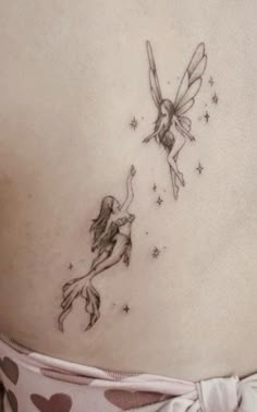 a woman with a tattoo on her stomach has a small fairy girl flying through the sky