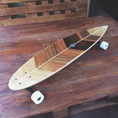 a wooden skateboard sitting on top of a wooden floor