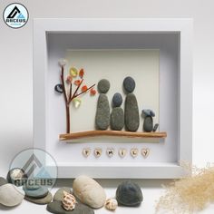 some rocks are sitting in a white frame