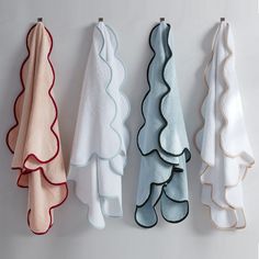 three towels hanging on the wall next to each other with ruffles in them