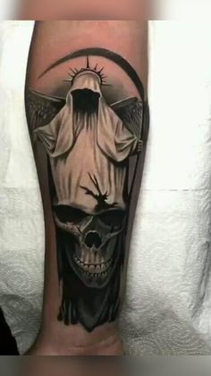 a person with a skull and cross on their leg is shown in this tattoo design