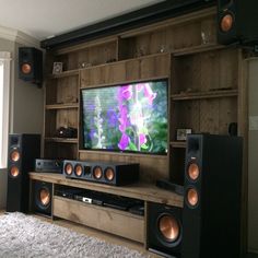 an entertainment center with speakers and a flat screen tv