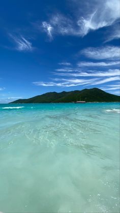 the water is very clear and blue with some clouds