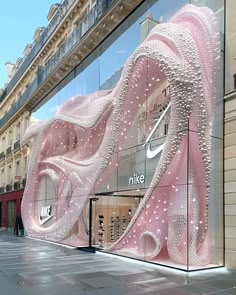 a pink nike store front on a city street