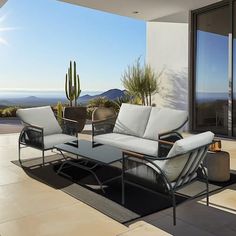 an outdoor living area with patio furniture and desert view