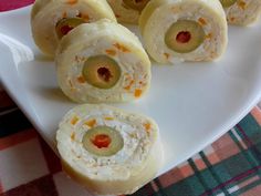 some food is on a white plate and sits on a plaid tablecloth with oranges