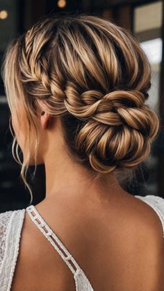 a woman with braids in her hair looking off to the side, wearing a white dress