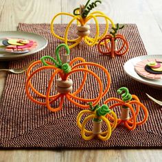 the table is set with colorful plates and place settings